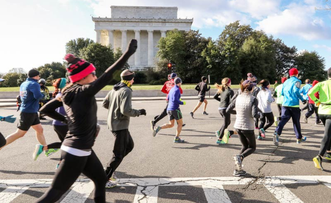 A diverse group of runners participating in a marathon, showcasing determination and teamwork along the race route.