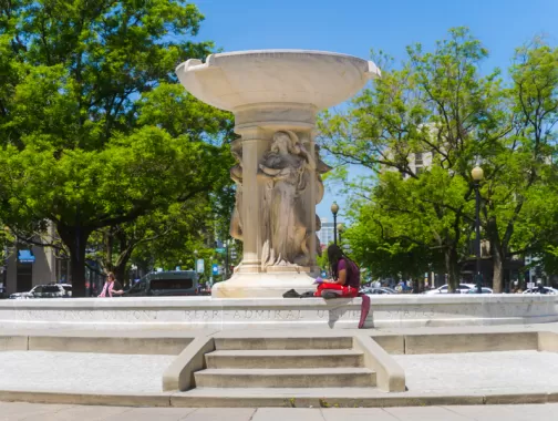 Person relaxing at Dupont Circle Monument 
