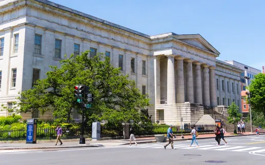 Pedestrians cross the street outside the National Portrait Gallery in Washington, DC.
