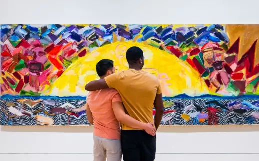 A couple looks at a colorful painting at the Phillips Collection.
